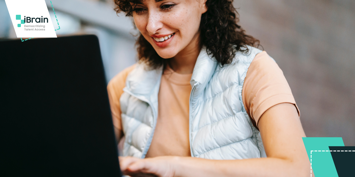 Curly haired woman using a laptop